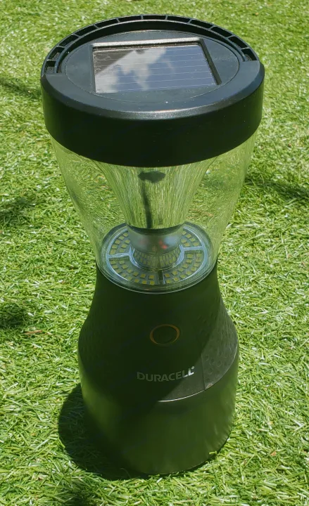 A black Duracell solar lantern on artificial grass, ideal for an RV rental. Charges in sunlight for outdoor illumination.. Other Other 2015