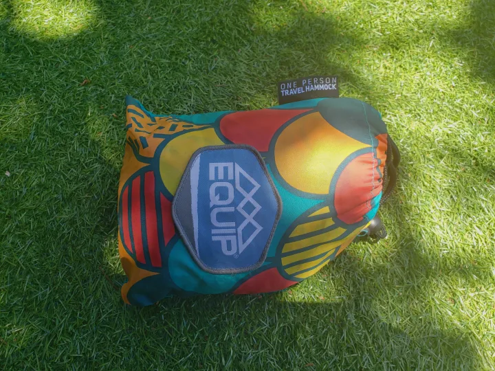 Brightly colored Equip one-person travel hammock on grass. Ideal for an RV rental outdoor escape.. Other Other 2015