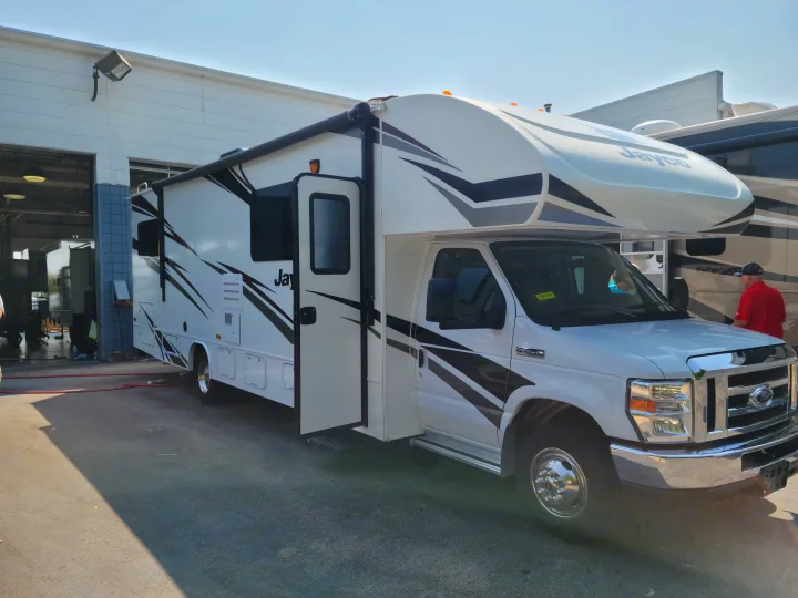 This white Jayco RV rental motorhome, with its sleek design & open door, is ready for your next adventure.. Jayco Redhawk 2020
