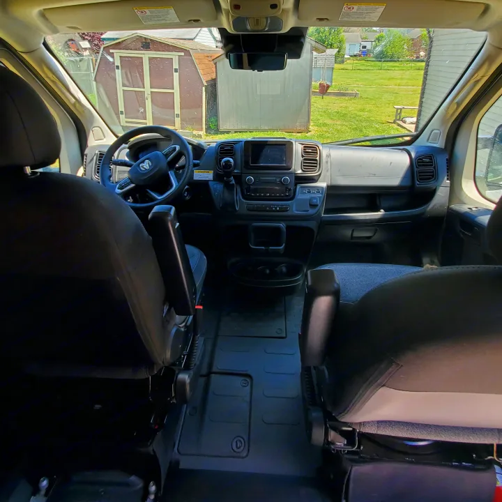 Spacious RV rental van interior showcasing dashboard, steering wheel, and front seats, ready for adventure.. Winnebago Solis 2022