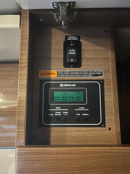 RV rental control panel: Monitor for water pump, heaters, tank/battery levels, plus slide room controls & warning.. Winnebago View 2015
