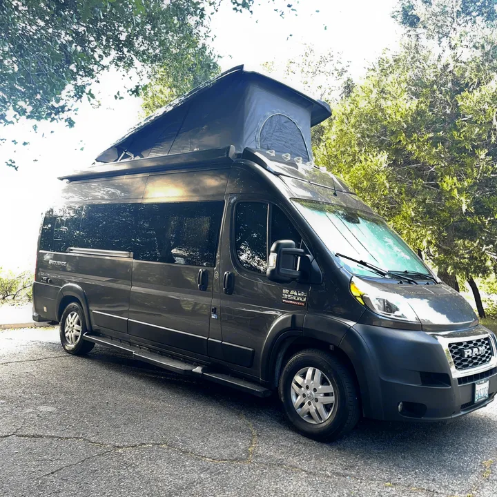 Dark grey Ram ProMaster camper van with a pop-top roof, ideal for an RV rental adventure.. Thor Sequence 2021