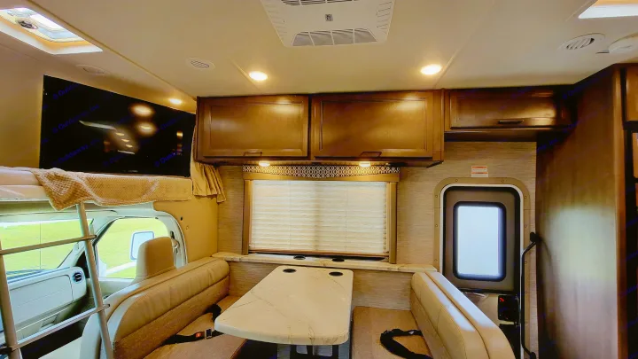 Step inside this RV rental! Features a comfortable dinette, overhead bunk bed, TV, and ample storage cabinets.. Thor Freedom Elite 2021