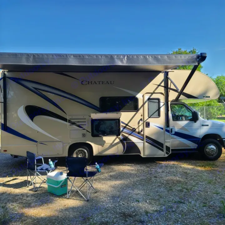 Relaxing scene with a Chateau RV rental, awning extended, and camp chairs/cooler ready for outdoor enjoyment.. Thor Motor Coach Chateau 2019