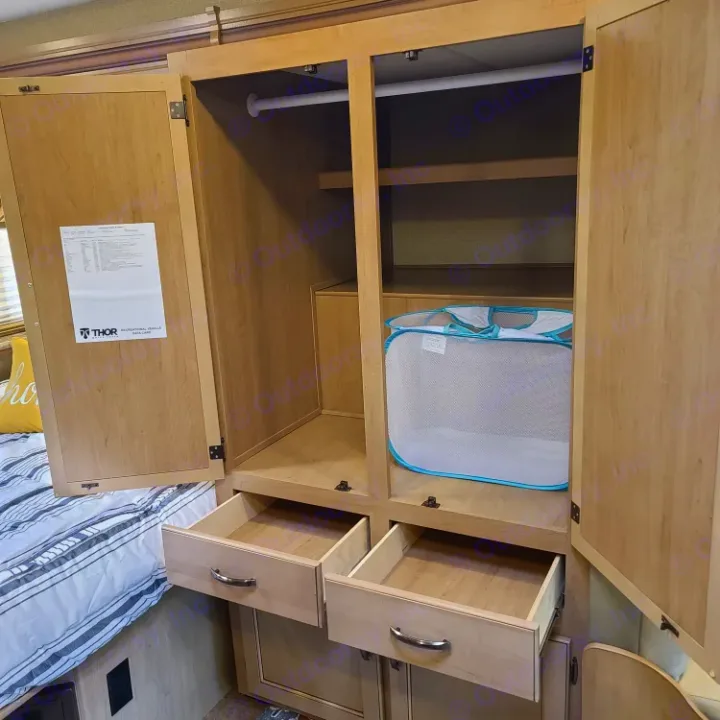 RV rental: Open wardrobe showing hanging space, shelves, drawers, and a mesh hamper for convenient storage.. Thor Motor Coach Chateau 2019