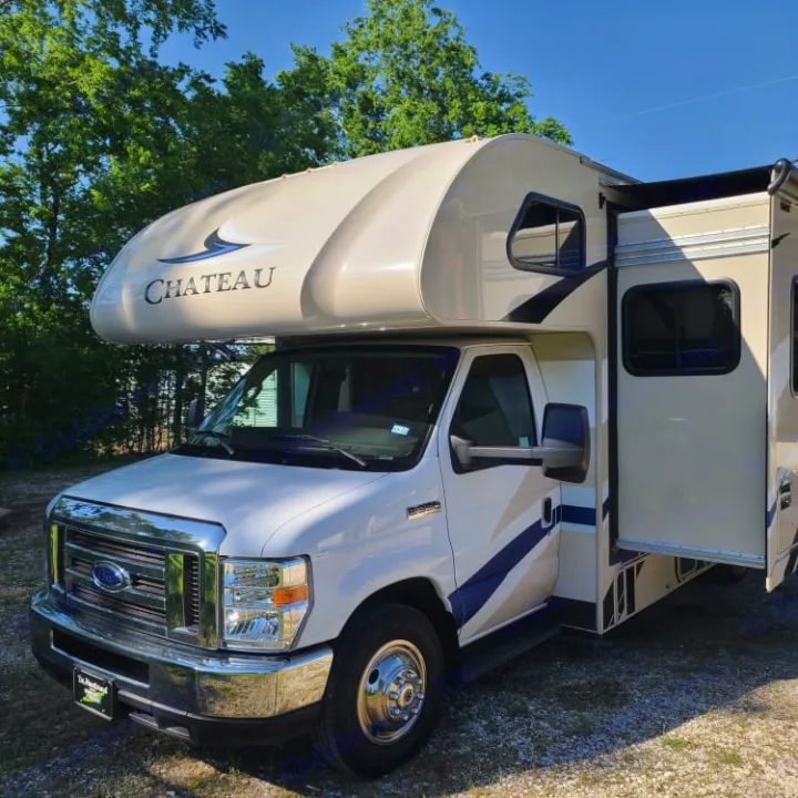 This bright Chateau Class C motorhome, ideal for rv rental, is seen parked with its side slide-out extended for extra space.. Thor Motor Coach Chateau 2019