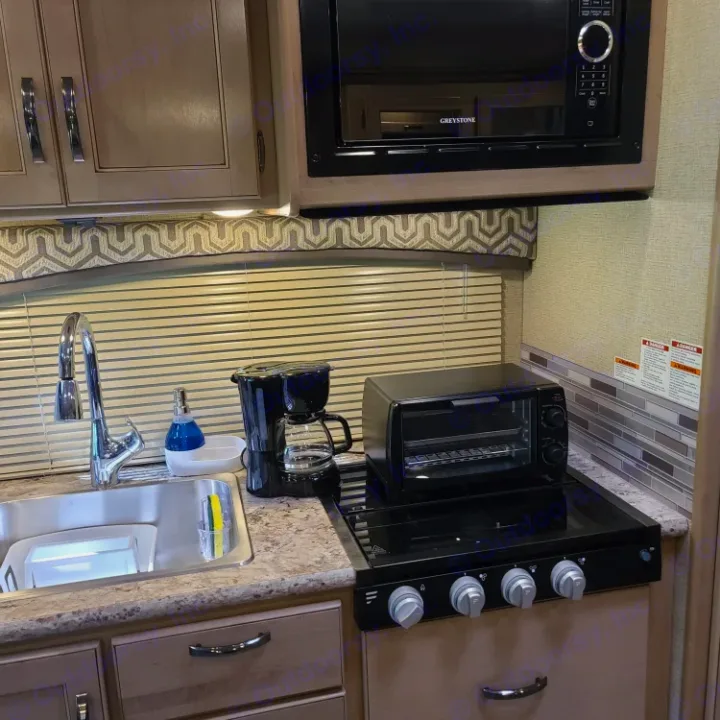RV rental kitchen: microwave, stovetop with toaster oven, sink, and coffee maker ready for your adventure.. Thor Motor Coach Chateau 2019
