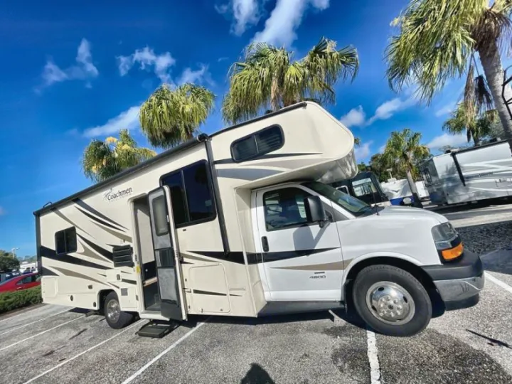 Your next adventure starts here! This Coachmen Class C rv rental, parked under palm trees on a sunny day, is ready for the road.. Coachmen Freelander 27QB 2020