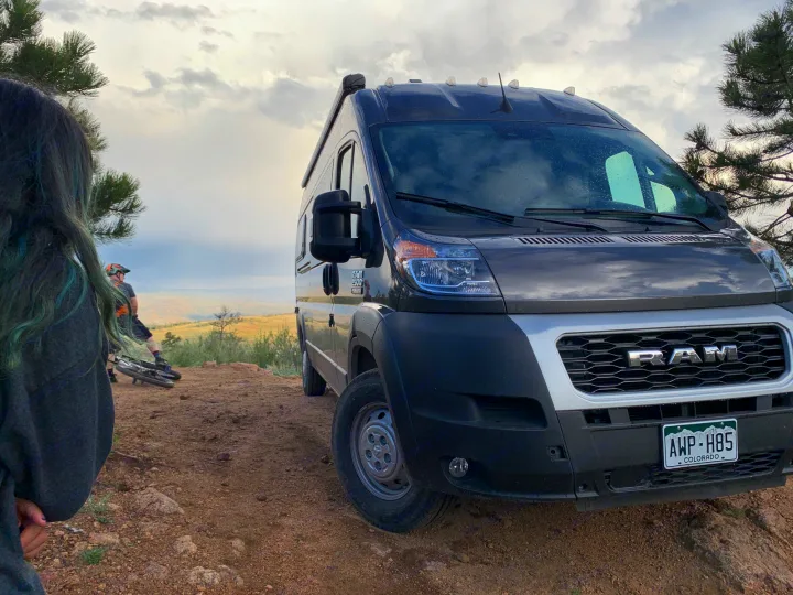 Off-road RV rental adventure! A dark Ram camper van & mountain bikers on a scenic Colorado dirt trail.. Dodge Ram Promaster 2500 2022