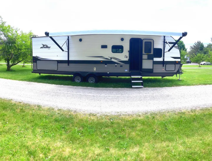 This RV rental, a Jay Flight travel trailer, is set up at a scenic spot, ready for adventure.. Jayco Jay Flight 2023