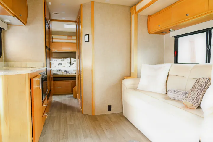 Explore this RV rental interior: modern living space, compact kitchen, and cozy bunk beds.. Wayfarer Wayfarer Motorhome 2017