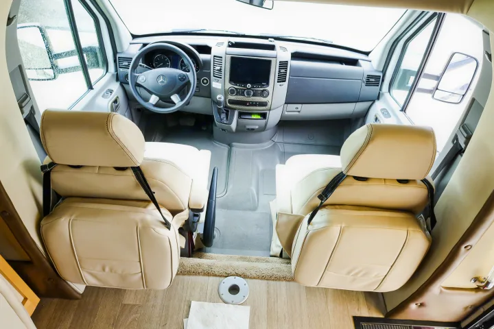 Inside a modern RV rental: light beige seats, spacious cockpit, Mercedes steering wheel. Ready for adventure!. Wayfarer Wayfarer Motorhome 2017