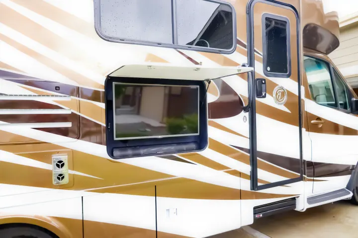 This RV rental features a side panel open, revealing an outdoor TV and soundbar, perfect for campsite entertainment.. Wayfarer Wayfarer Motorhome 2017