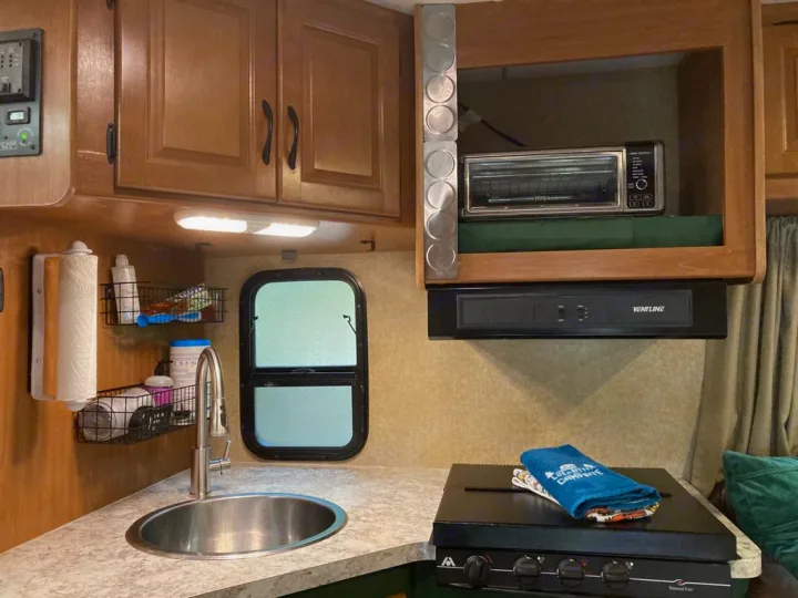 An RV rental kitchen features a sink, stove, toaster oven, and smart storage for your trips.. Thor Majestic 2016