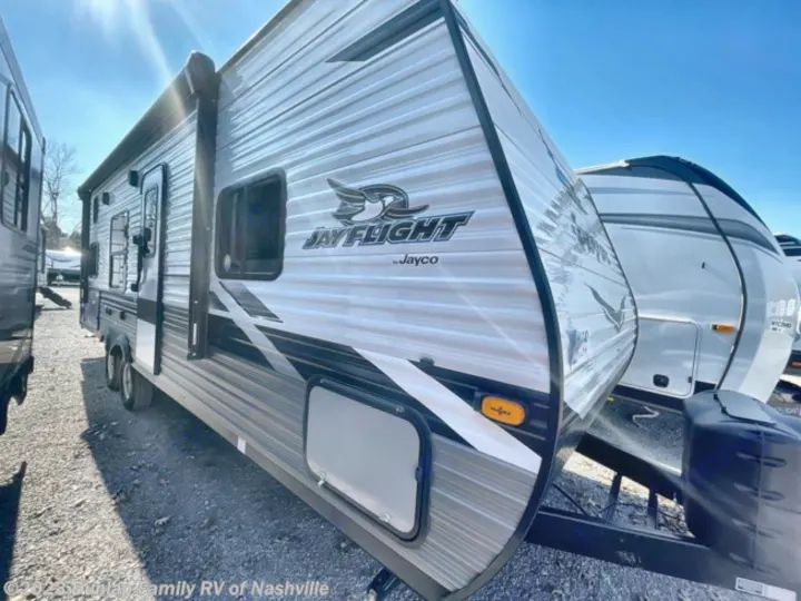 RV rental: Gray & white Jayco Jay Flight travel trailer, an RV parked on gravel, with storage door.. Jayco Jay Flight SLX 2022