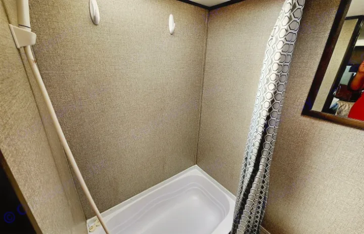 RV rental: Compact shower/tub with white basin, handheld shower, and hexagon-patterned curtain.. Jayco Jay Flight SLX 2020