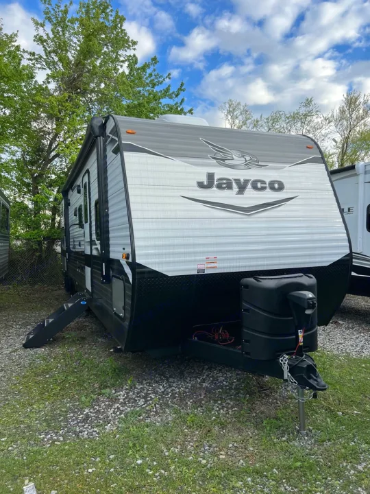 A sleek, modern Jayco travel trailer, ideal for an RV rental. Shown parked outdoors under a blue sky, ready for adventure.. Jayco Jay Flight 2022