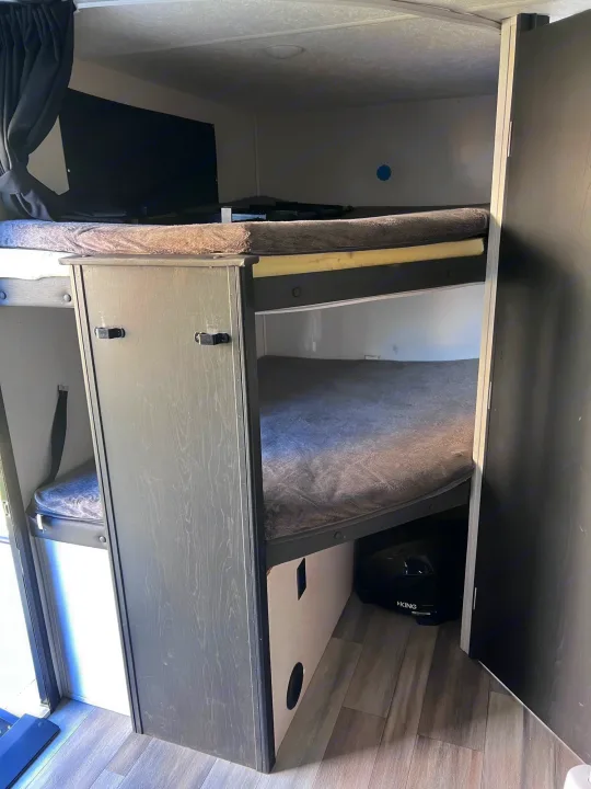 RV rental bunk beds with TV and storage offer cozy sleeping arrangements in a compact space.. Coachmen freedom express 287bhds 2022