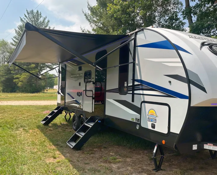 This Alpha Wolf travel trailer RV rental, featuring an extended awning and steps, is ready for adventure with solar power.. Forest River Cherokee Alpha Wolf 2022