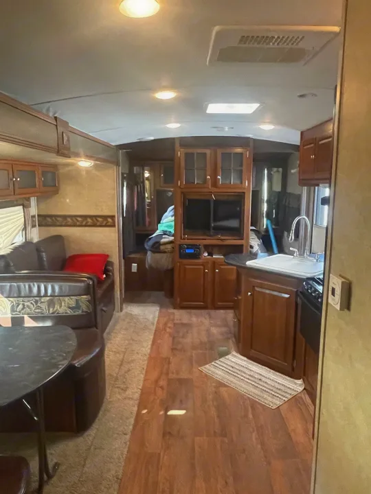 Experience an RV rental: a well-appointed interior with wood flooring, kitchen, living, and entertainment areas for your mobile adventures.. Keystone Bullet Premier 2014