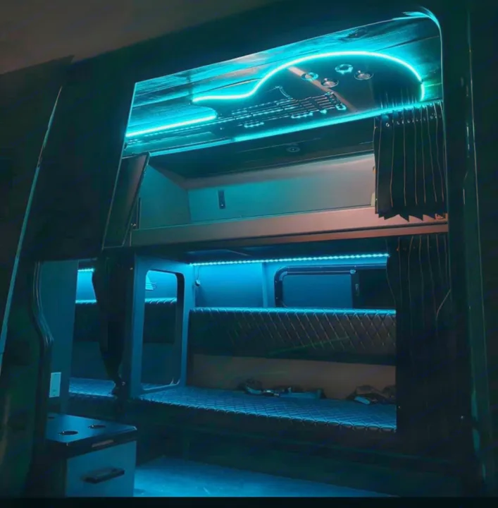 Inside a modern rv rental: blue LED lit bunks & a striking guitar-shaped ceiling. A unique camper experience.. Mercedes Sprinter Freight Liner 2020