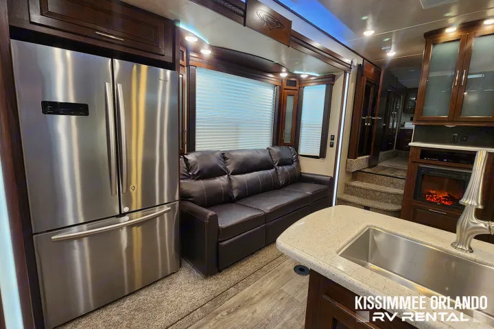 RV rental: Spacious interior with stainless steel fridge, leather sofa, kitchen island, and cozy electric fireplace.. Heartland Cyclone 2019