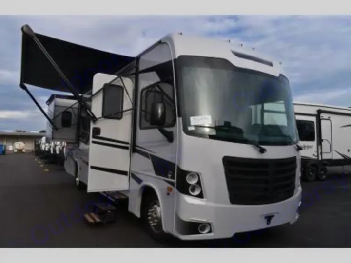 Spacious white motorhome for rv rental, featuring an extended awning and open entry door. Ready for outdoor travel.. Forest River FR3 30DS 2023