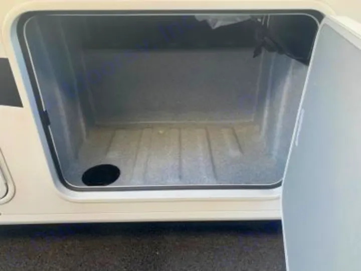 RV rental: Open, empty, clean exterior storage compartment with a drain, ready for your gear.. Forest River FR3 30DS 2023