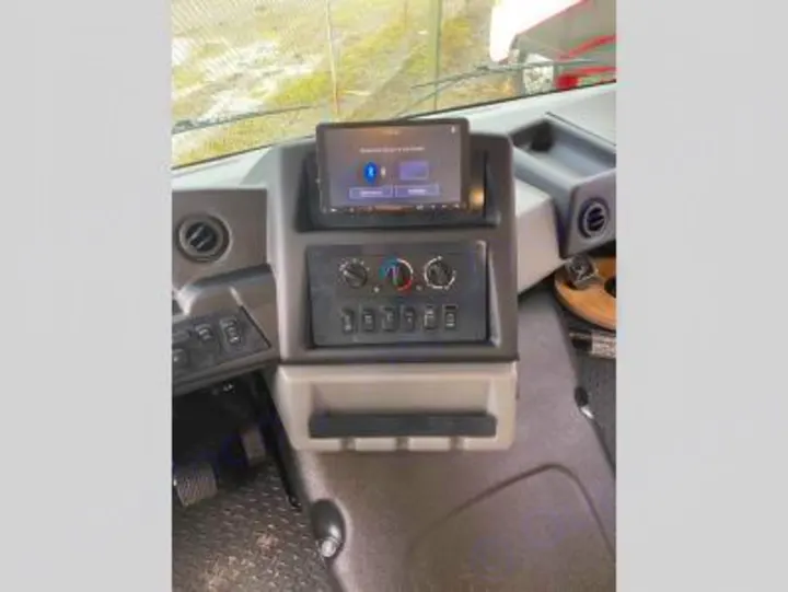 RV rental dashboard: touchscreen media display, climate control knobs, and multiple switches. Essential controls for your journey.. Forest River FR3 30DS 2023