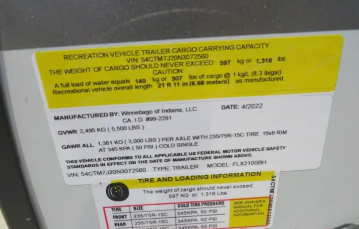 RV rental trailer's official safety label detailing cargo capacity, GVWR, GAWR, and tire pressure specifications.. Winnebago Micro Minnie FLX 2100BH 2022