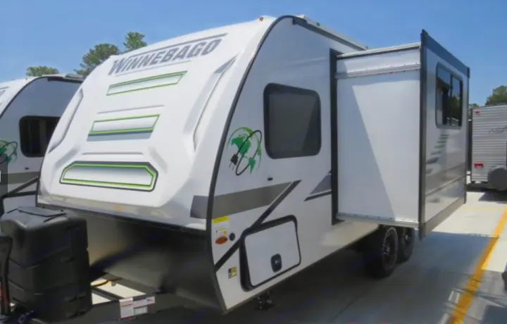 This white Winnebago travel trailer, ideal for an RV rental, features green accents and an open slide-out.. Winnebago Micro Minnie FLX 2100BH 2022