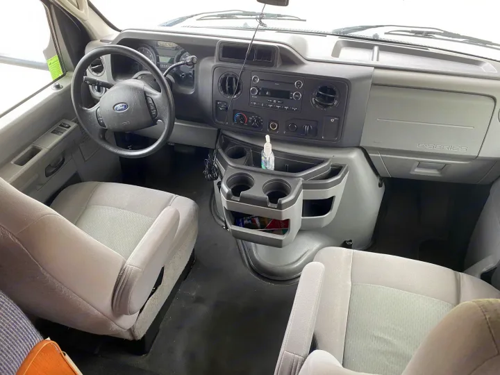 RV rental: View of the Ford E-Series cockpit, featuring the dashboard, steering wheel, and front seats of the spacious interior.. Thor Majestic 2018