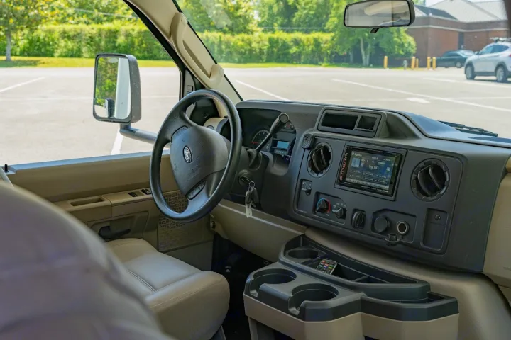 Spacious RV rental interior: driver's view of the dashboard, Ford steering wheel, and controls. Ready for your journey.. Jayco Redhawk 2019