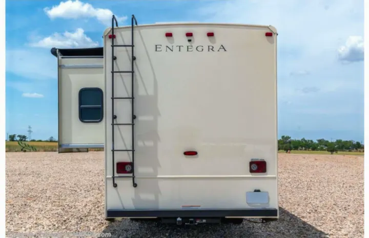 Rear view of an Entegra RV showing its ladder and slide-out. Explore the open road with an rv rental!. Entegra Coach Vision 2021