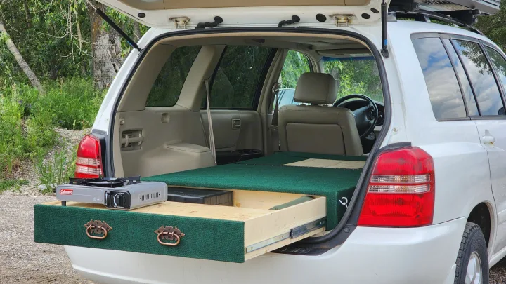 Compact RV rental SUV: custom tailgate kitchen with stove & sleeping platform, ready for car camping adventures.. Toyota Highlander 2005