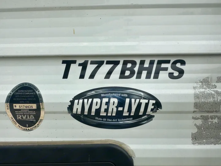 A white T177BHFS travel trailer, an RVIA-certified Hyper-Lyte model, suitable for an rv rental adventure.. Forest River Evo 2019