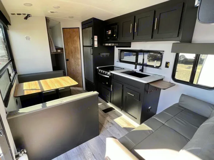 Modern RV rental interior: kitchen, dinette, and lounge area, ready for adventure.. Keystone RV Springdale 2022