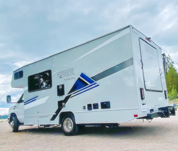 Side view of a grey Coachmen Cross Trail RV for rv rental, parked outdoors, ready for your next adventure.. Forest River Coachmen Cross Trail XL 2022