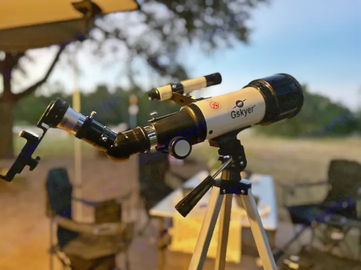 A Gskyer telescope is set for stargazing on an RV rental trip, ideal for celestial camping views.. Sunset Park RV SunRay 2023