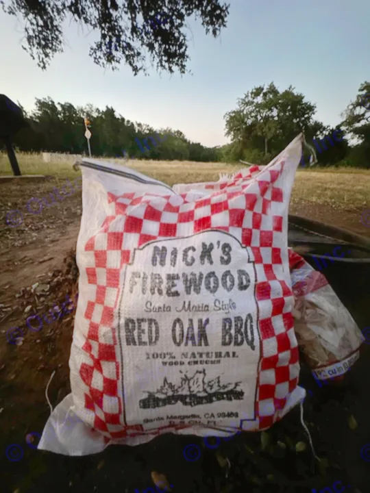Bag of Nick's Red Oak BBQ firewood for your RV rental adventure, ready for Santa Maria style grilling.. Sunset Park RV SunRay 2023