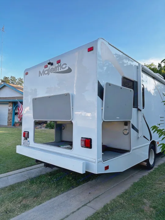 White Class C Majestic RV rental with open, accessible exterior storage. Ready for travel!. Thor Majestic 2015