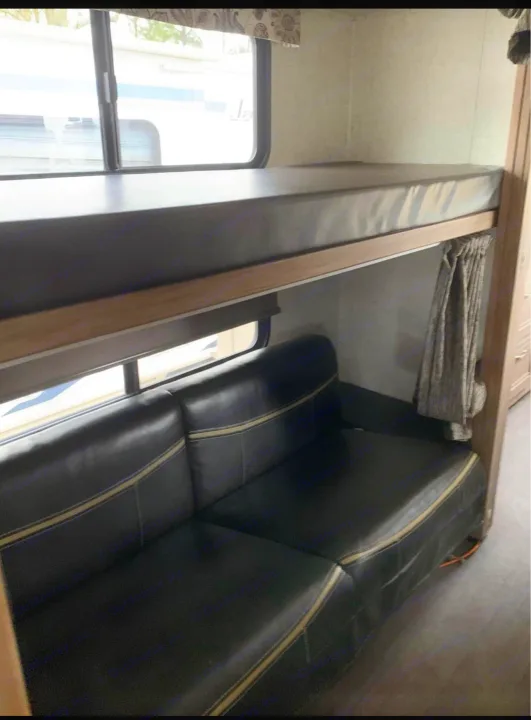 Inside an RV rental: cozy bunk beds over a comfy sofa, perfect for family travel.. Forester LE 2018