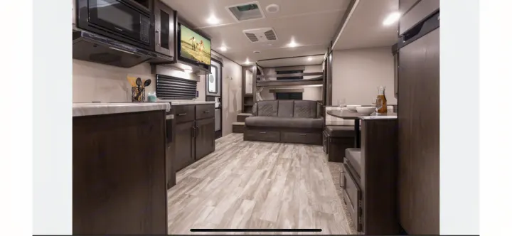 Spacious RV rental interior featuring a kitchen, living area with sofa bed & bunks, and a dinette.. Grand Design Transcend Xplor 2021