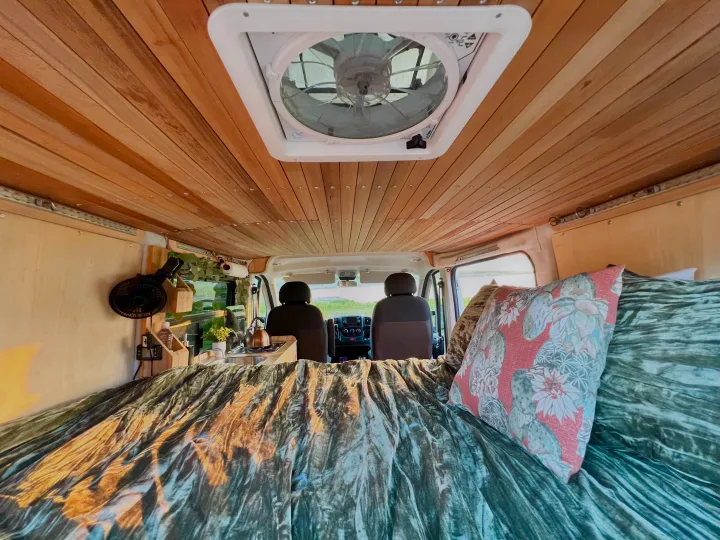 Step into this custom rv rental featuring a beautiful wood-paneled ceiling, comfy bed, and compact kitchenette.. Dodge RAM Promaster 2017