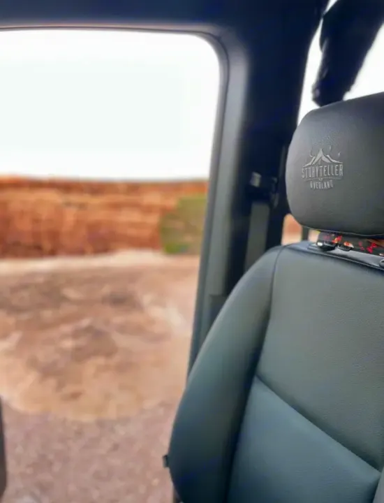 Inside an RV rental, looking out at the vast overland landscape. Storyteller Overland seat visible.. Mercedes-Benz sprinter 2023