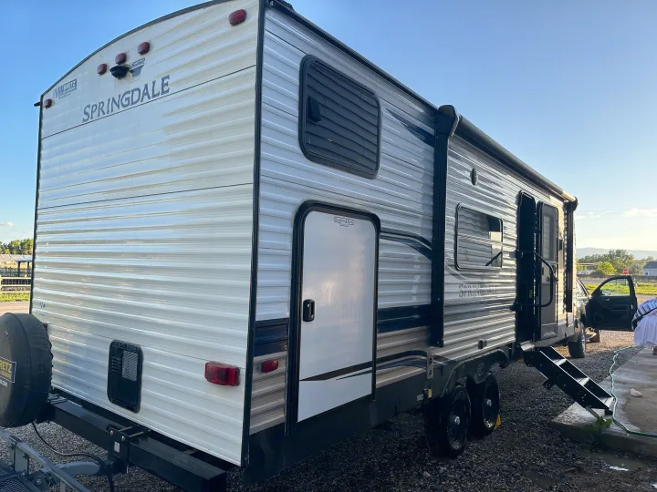 Side view of a "Springdale" travel trailer, ideal for an RV rental vacation.. Keystone RV Springdale 2021