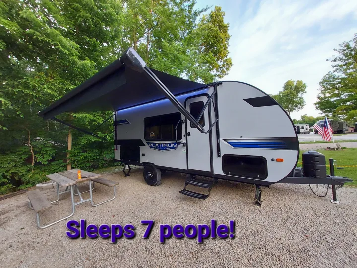 Modern RV rental at a scenic campground, featuring an awning and sleeping 7 people. Perfect for outdoor adventures.. Forest River Salem FSX Platinum 2023
