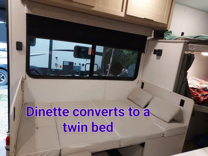 This RV rental's dinette conveniently converts into a twin bed, maximizing space in its cozy interior.. Forest River Salem FSX Platinum 2023