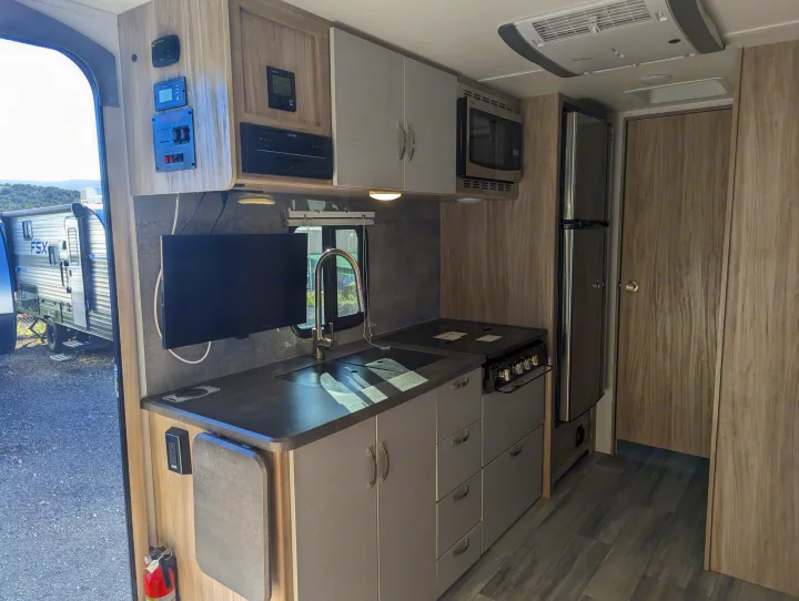 This RV rental offers a well-equipped kitchen area with a sink, stove, microwave, fridge, and entertainment.. Winnebago Micro Minnie 2022