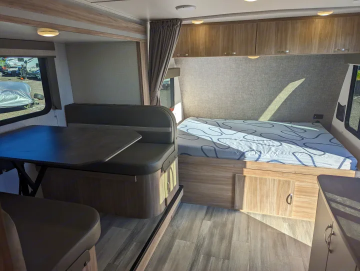 RV rental interior: Featuring a modern dinette area, comfortable bed, and ample storage, ready for your next adventure.. Winnebago Micro Minnie 2022